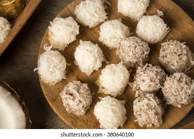 Peruvian cocadas, you can see in the image pieces of coconut with appetite flattened balls made with grated coconut and sugar, some look white other brunettes.