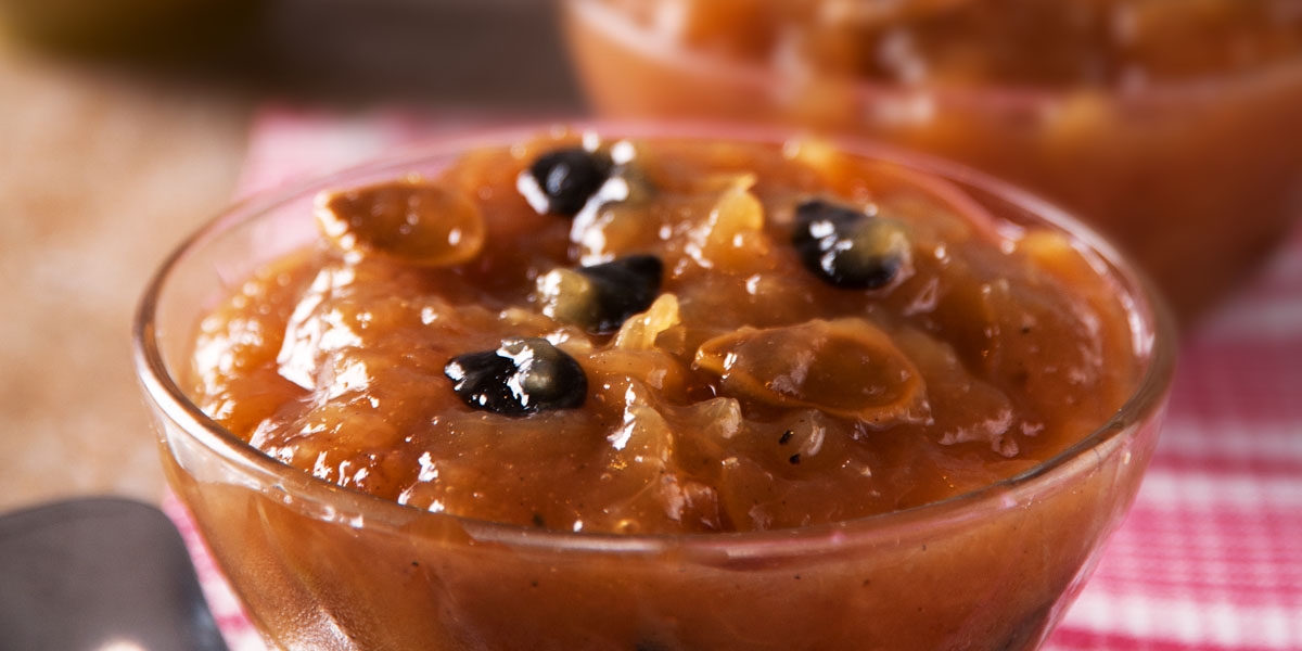 The mazamorra de calabaza served in glass glasses. This dessert presents a rich thick texture of opaque yellow with some nuts such as decoration.